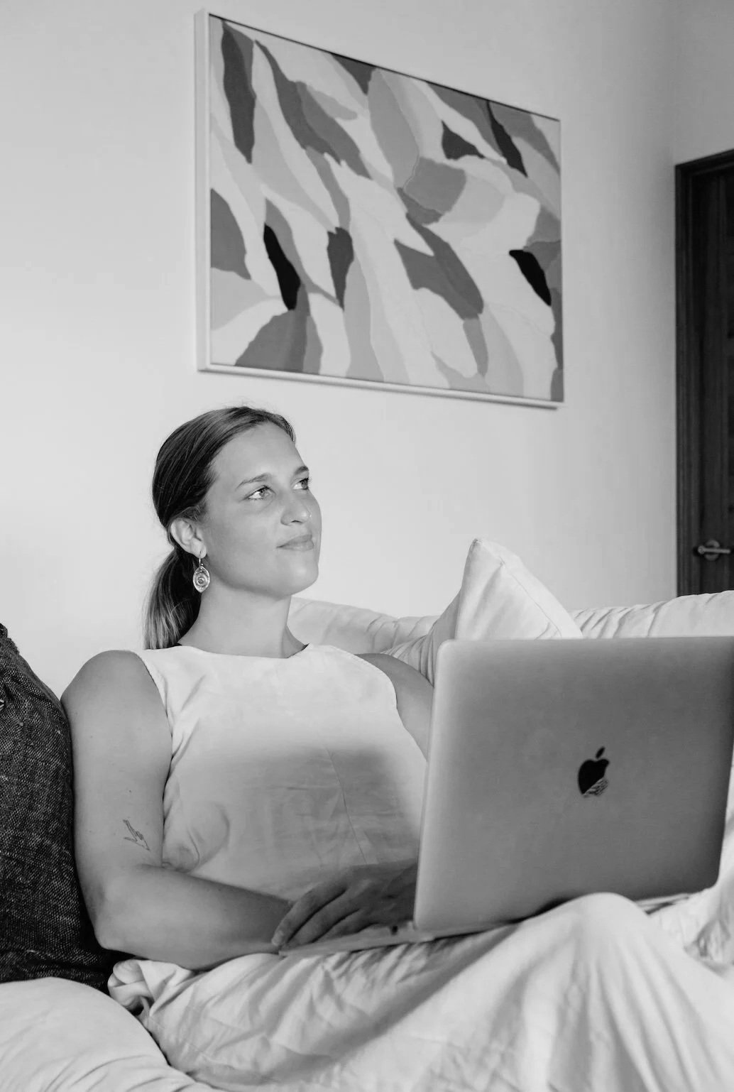 Loes settled on the couch with her laptop during an online session